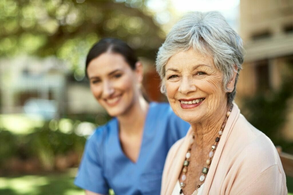 Senior outside retirement home with nurse