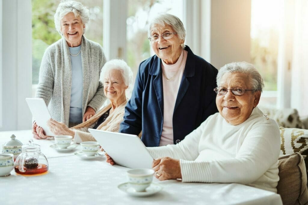 Senior women learning with tablets at retirement home