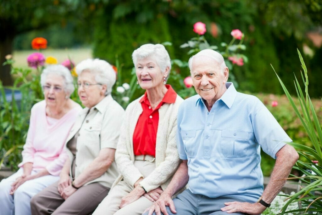 Senior women and man outside retirement home