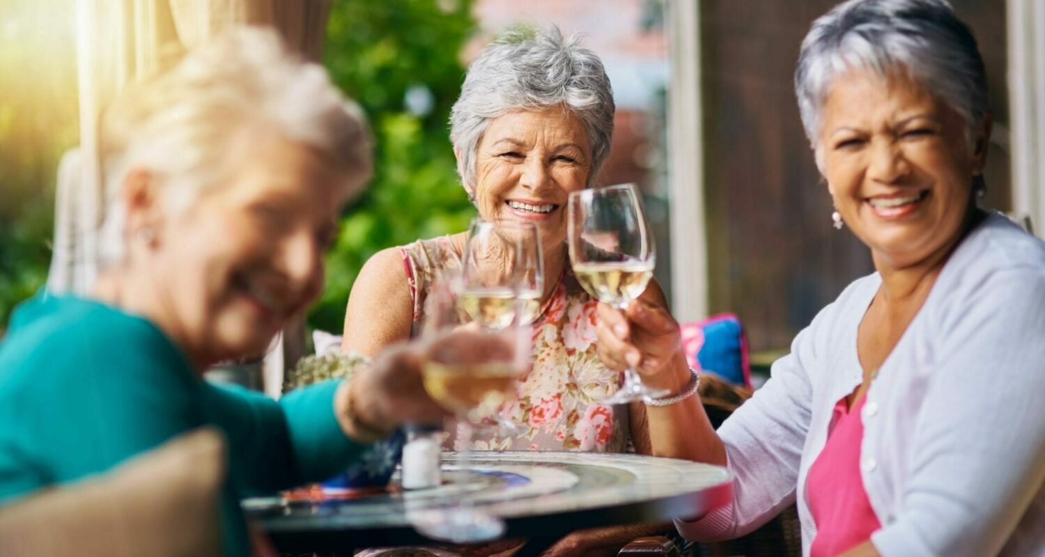 Seniors enjoying wine with friends at independent living